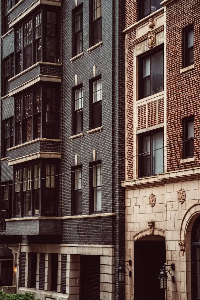 gallery-2 A modern facade blends with classic brick architecture in Chicago's urban landscape.