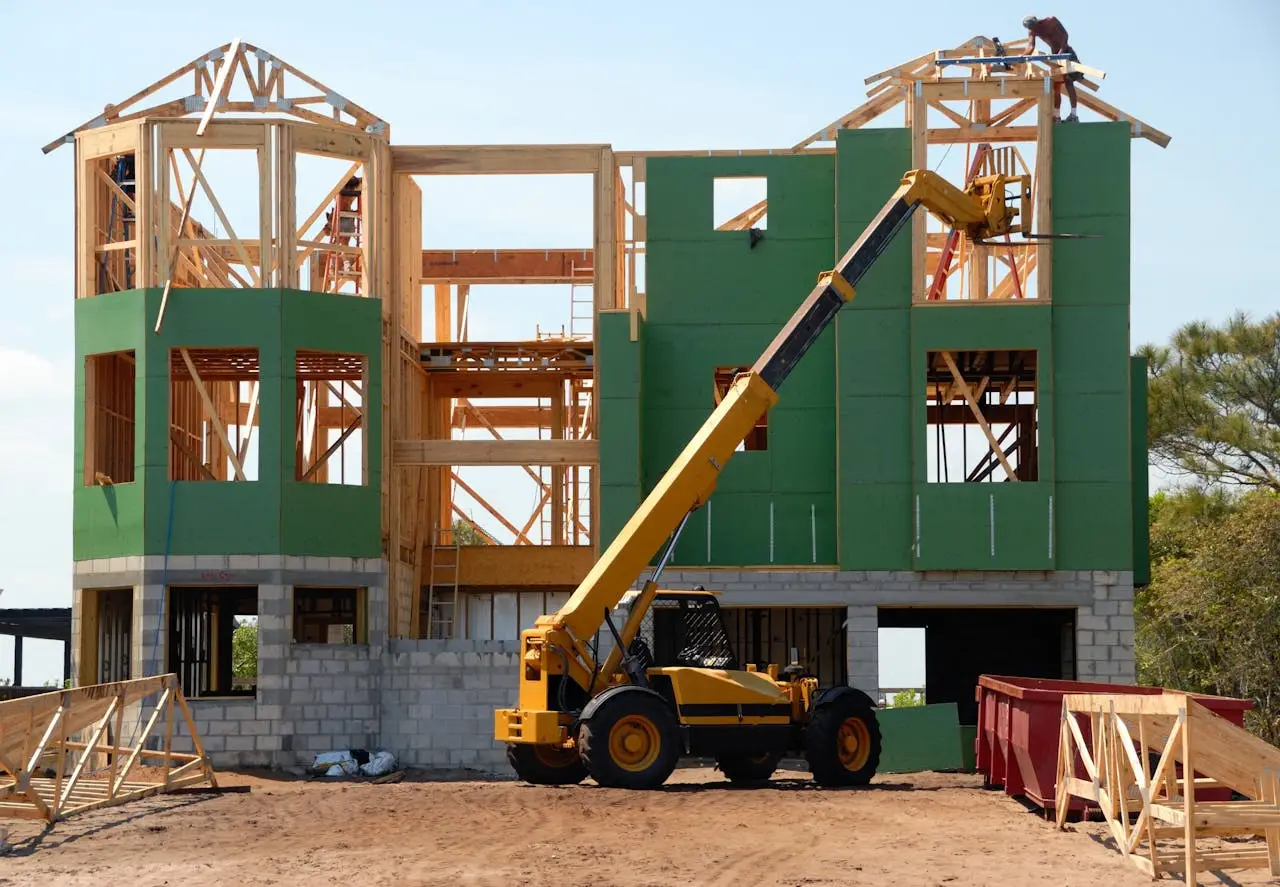 gallery-3 A multi-story wooden house under construction using a crane on a sunny day.