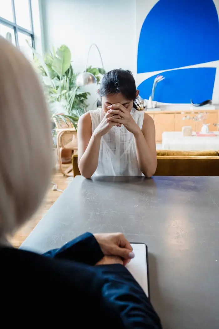 A woman in distress during a counseling session, highlighting emotional intimacy and support.
